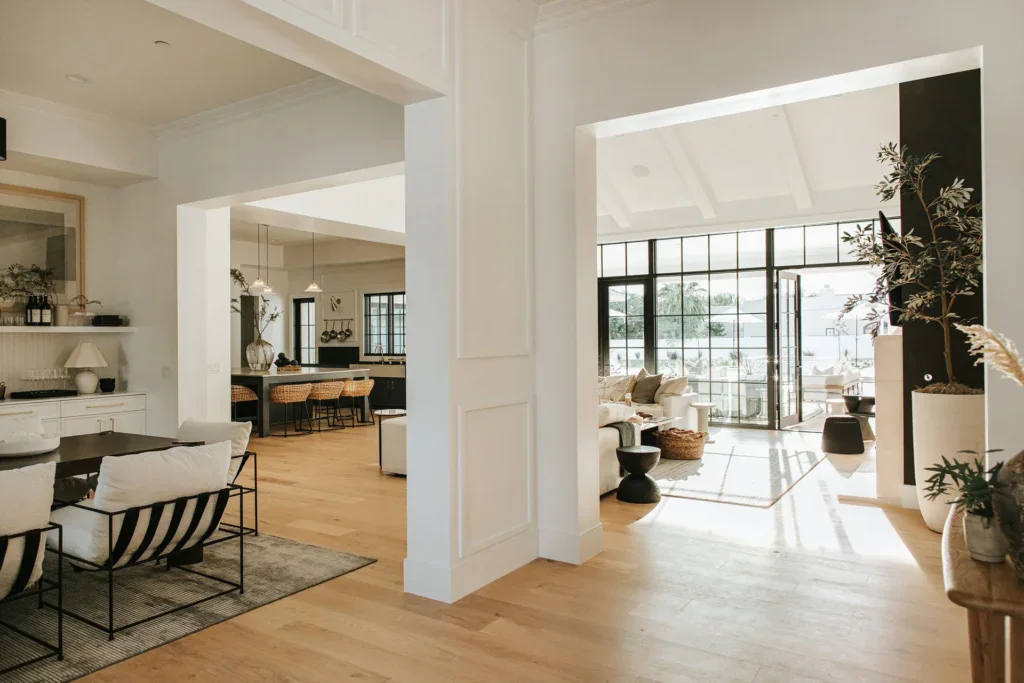 Bright open-concept home with kitchen, living room, and large windows