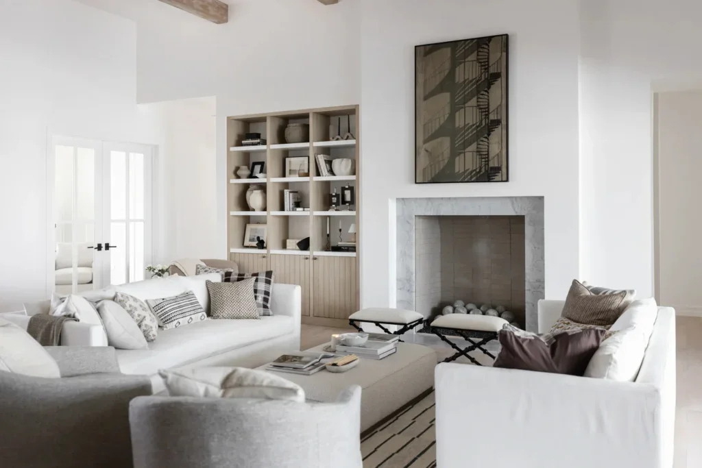 Elegant white living room with fireplace and built-in shelves