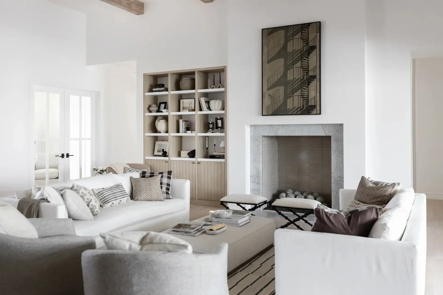 Elegant white living room with fireplace and built-in shelves