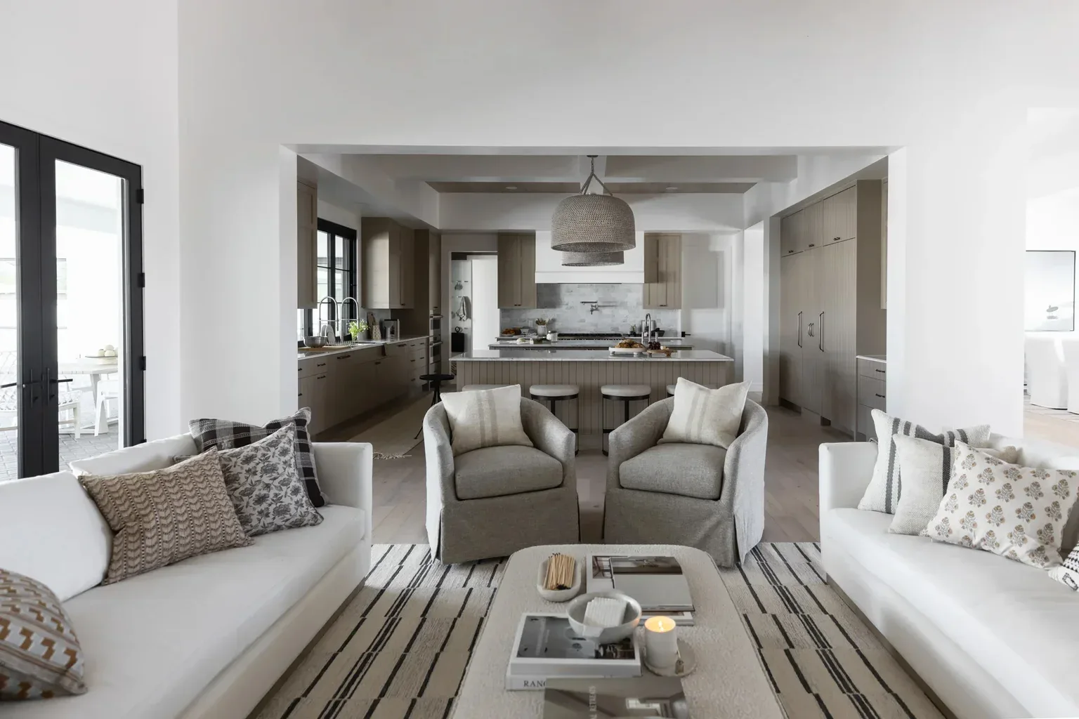 Modern open-concept living room and kitchen in neutral tones