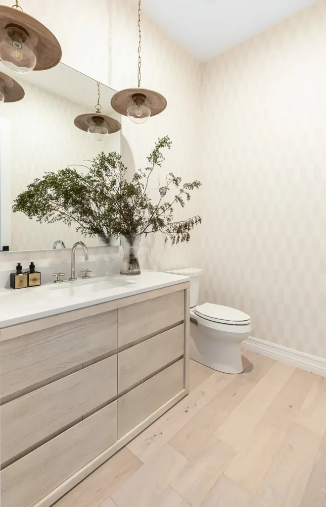 Modern neutral bathroom with wood vanity and hanging pendant lights