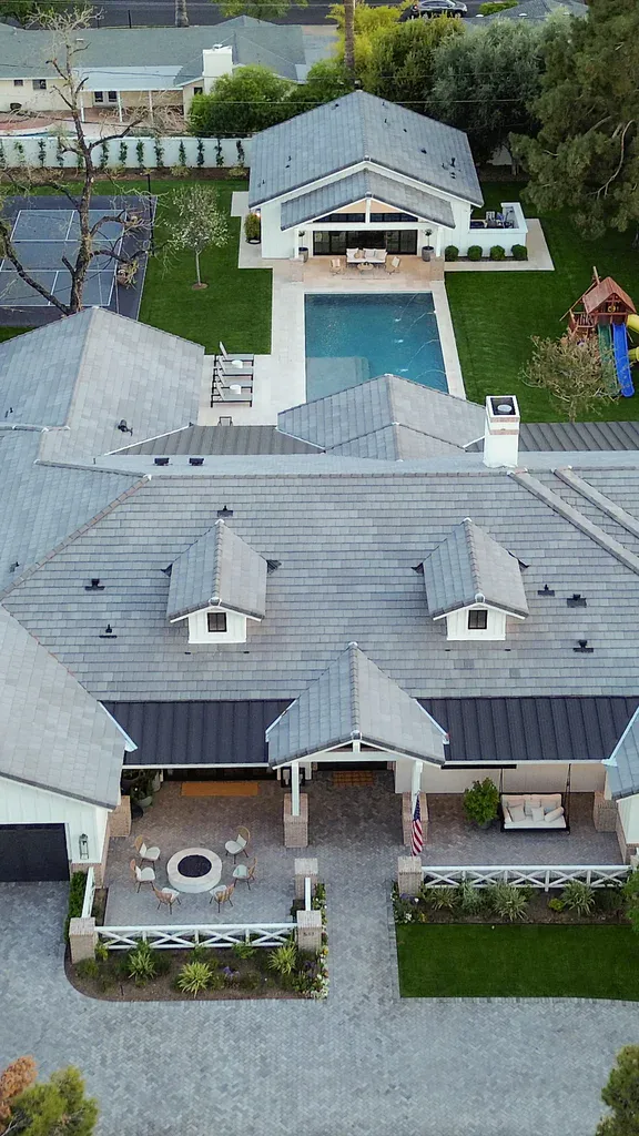 Aerial view of luxury home with pool and backyard