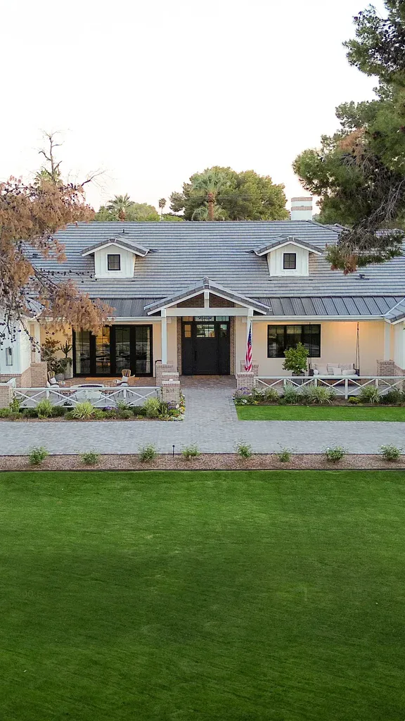 Charming suburban home with green lawn and American flag