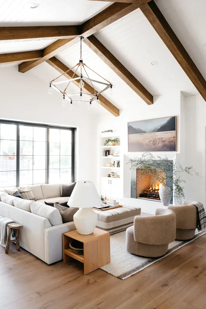Bright living room with vaulted ceilings, wood beams, and fireplace