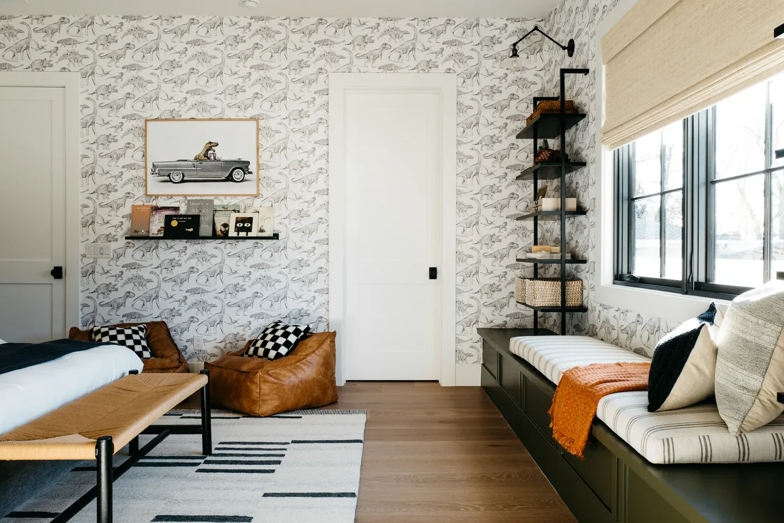Boy's bedroom with dinosaur wallpaper, leather bean bag, window seat