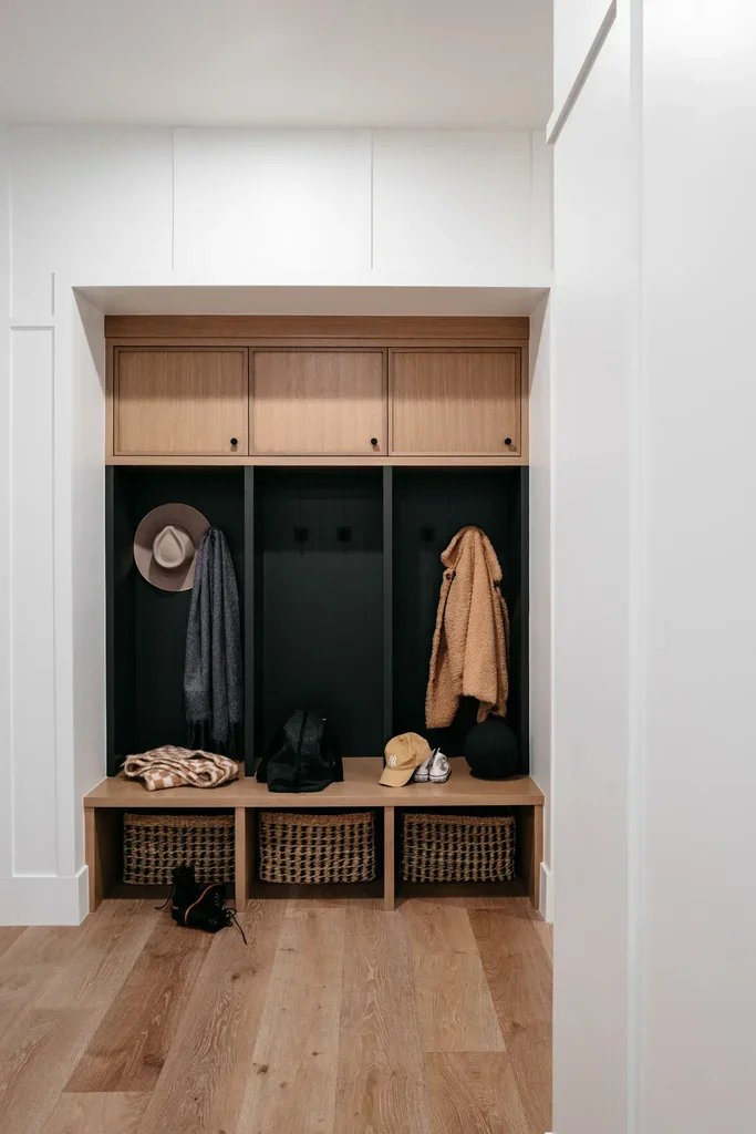 Modern mudroom with wood lockers, bench, and wicker baskets