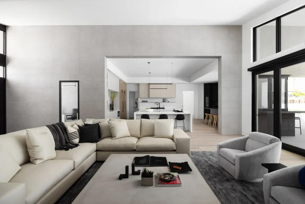 Modern open-plan living room with cream sectional sofa and kitchen