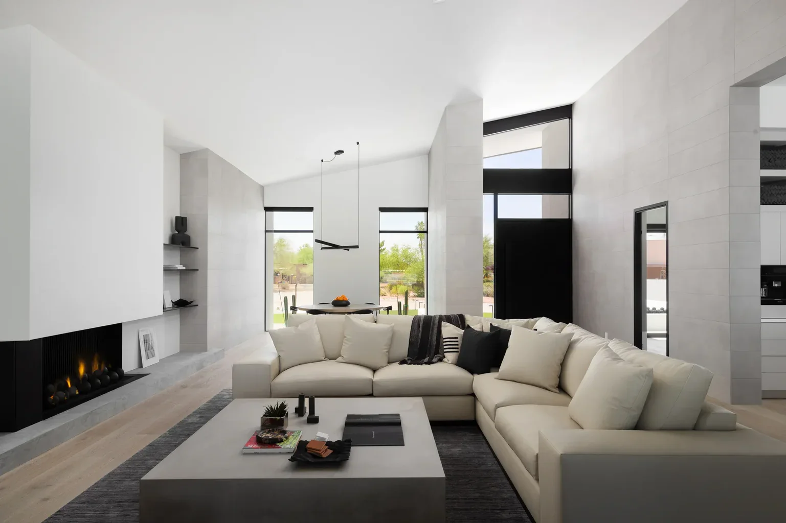 Modern minimalist living room with fireplace and sectional sofa