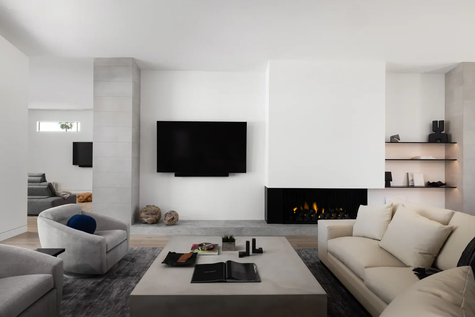 Modern minimalist living room with fireplace and wall-mounted TV