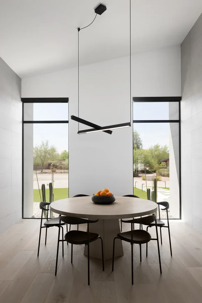 Modern minimalist dining room with round table and pendant light