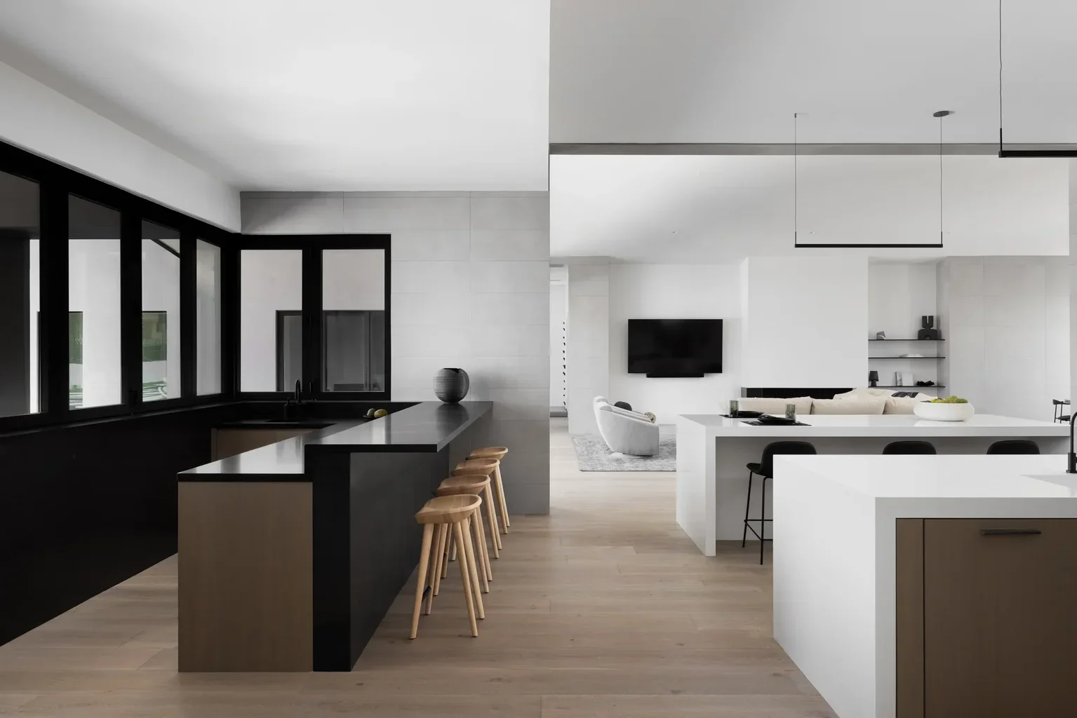Modern open-concept kitchen and living area with black and white design