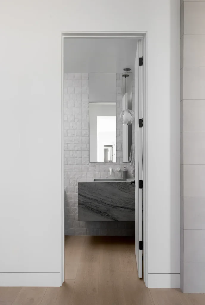 Modern bathroom with marble vanity and white subway tile walls