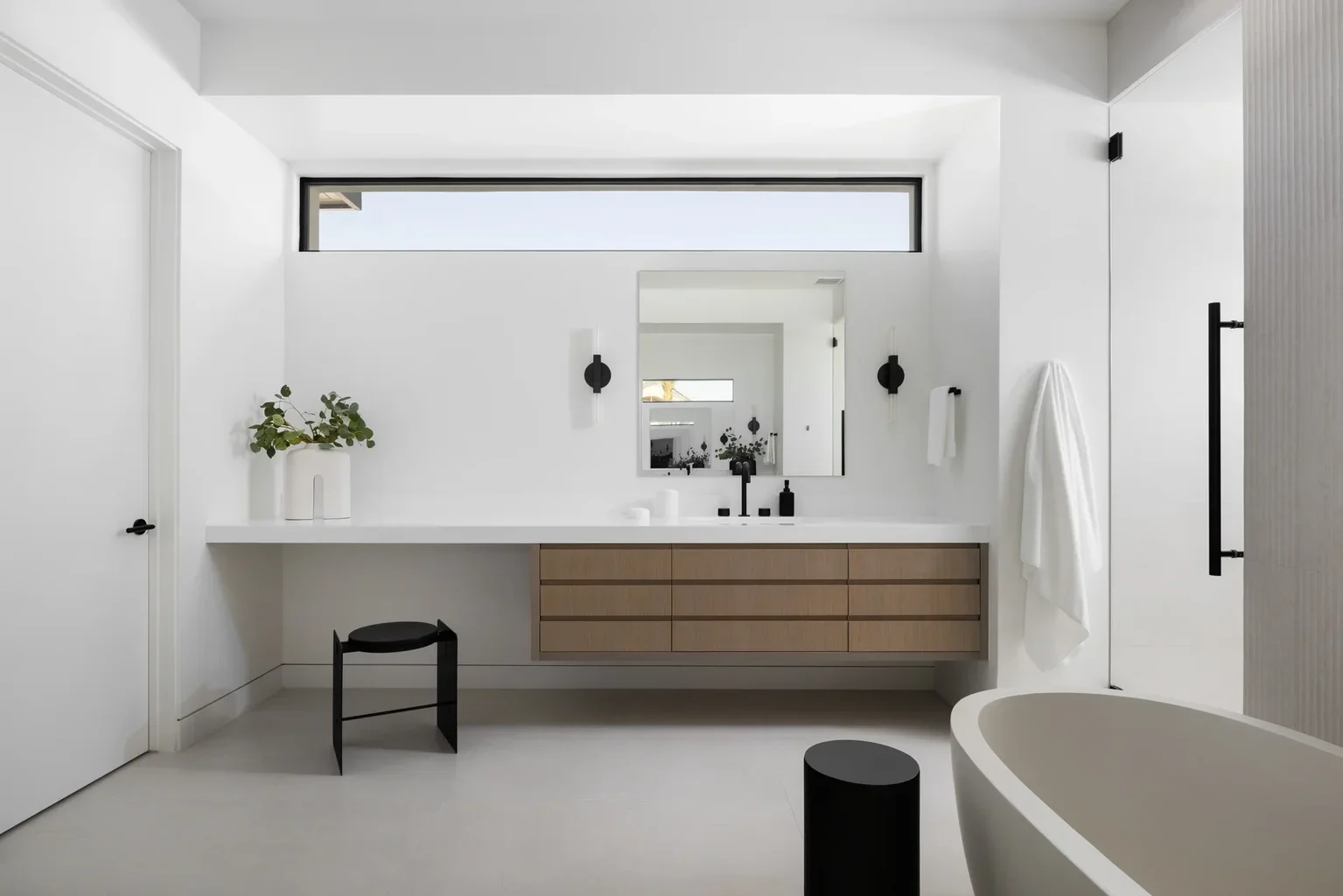 Modern minimalist bathroom with floating vanity and freestanding tub