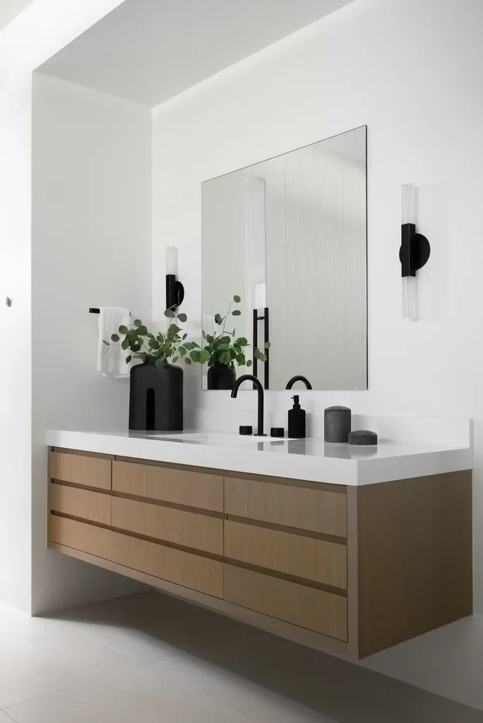 Modern floating wood bathroom vanity with black fixtures and mirror