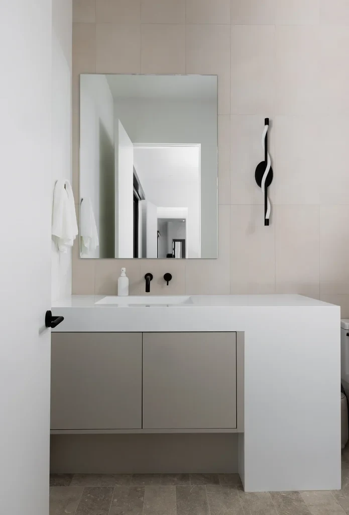 Modern minimalist bathroom vanity with mirror and black fixtures