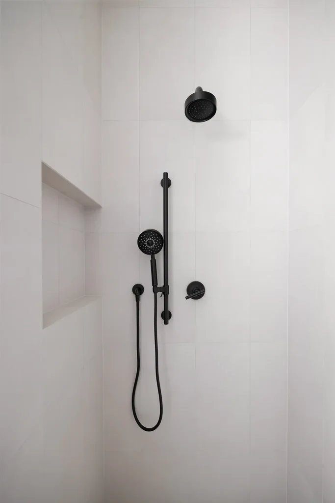 Modern shower with matte black fixtures and white tile walls