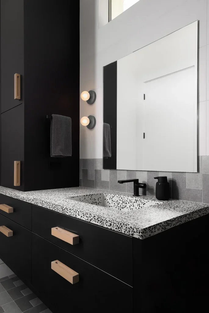 Modern black bathroom vanity with terrazzo countertop and mirror