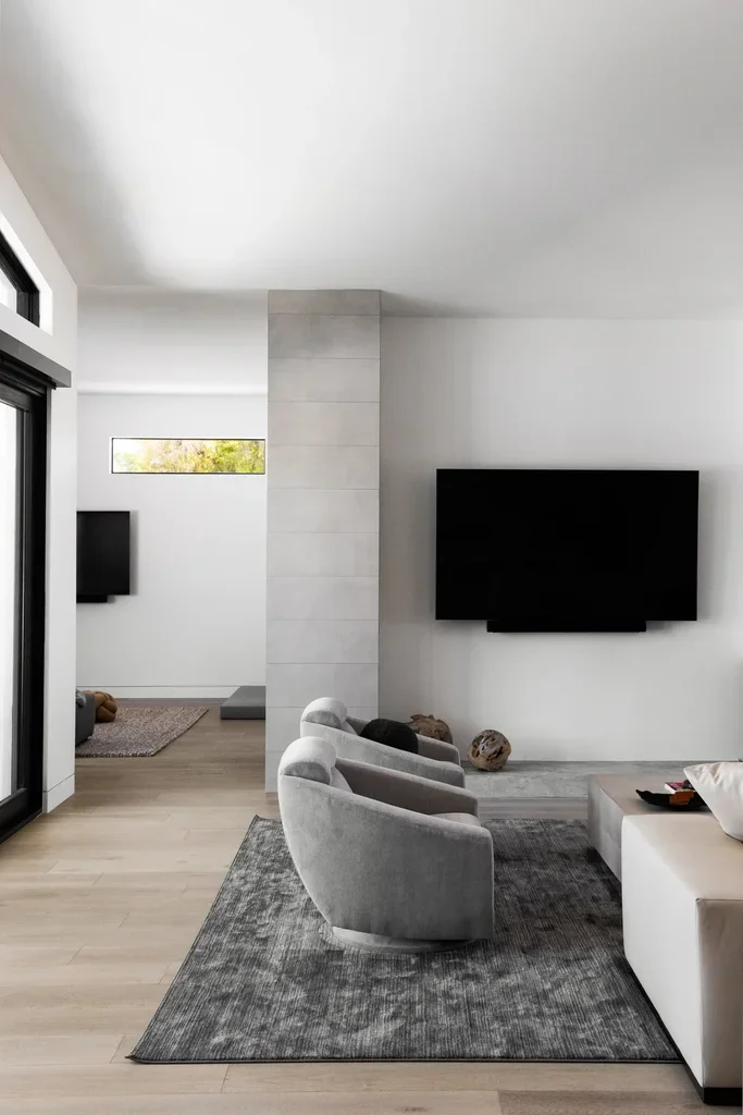 Modern minimalist living room with gray sofa and wall-mounted TV