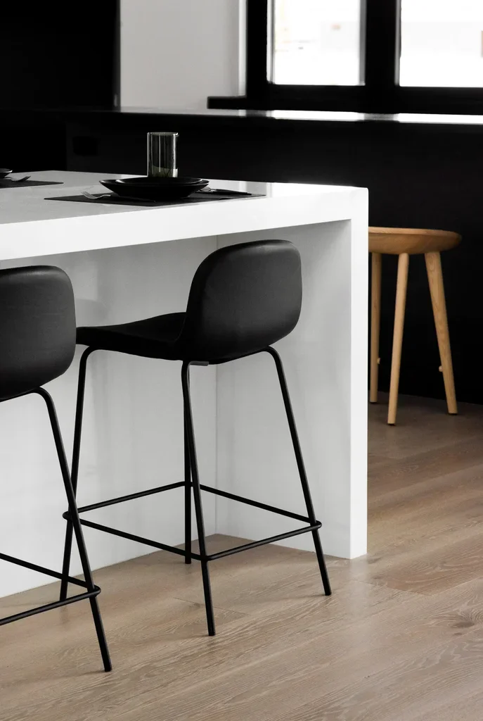 Black modern bar stools at white kitchen island