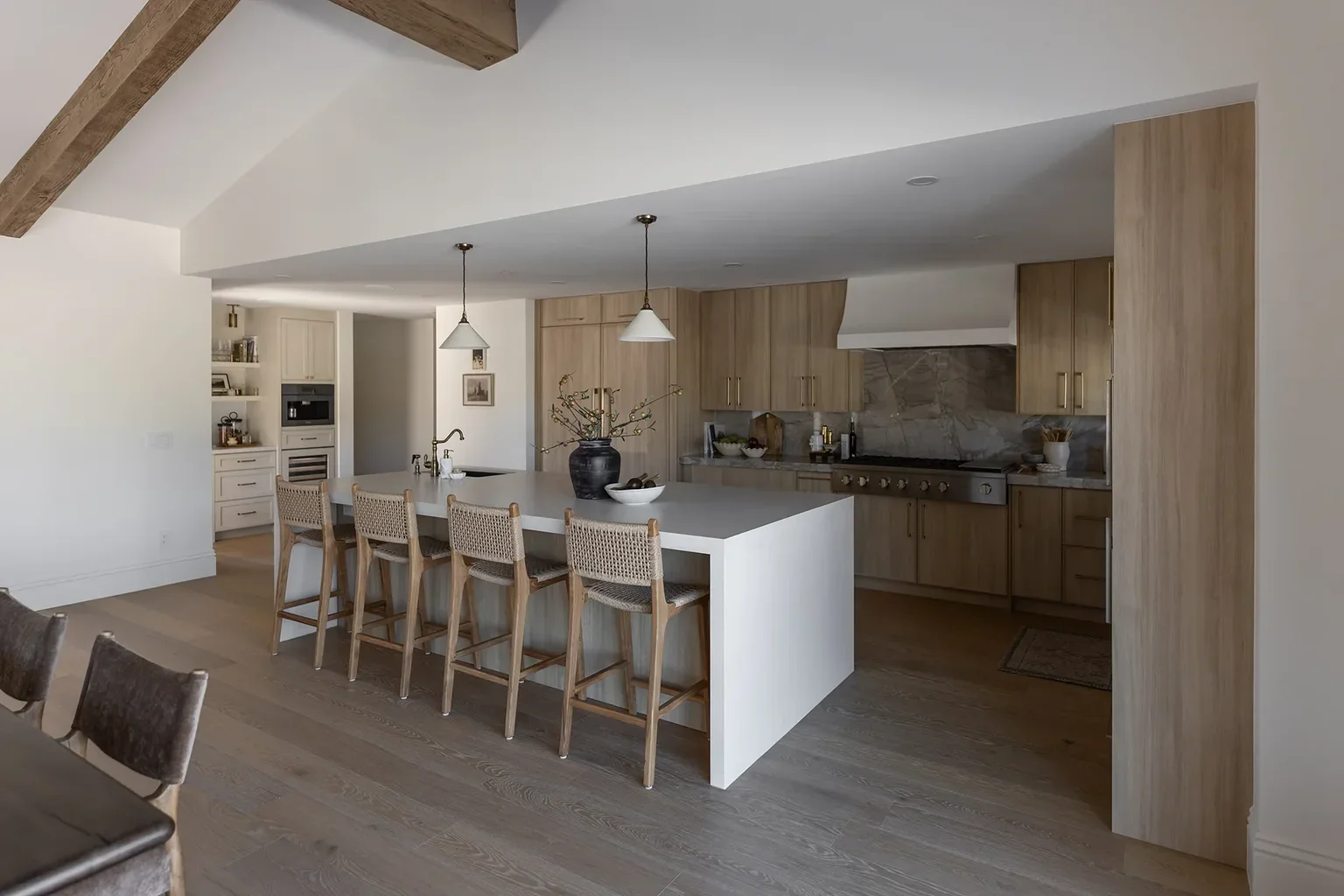 Modern kitchen with wood cabinets, large island, and bar stools