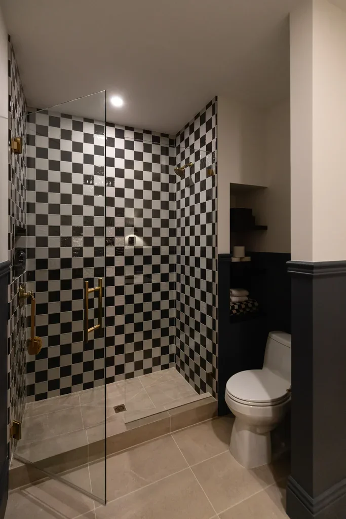 Bathroom with black and white checkered tile glass shower