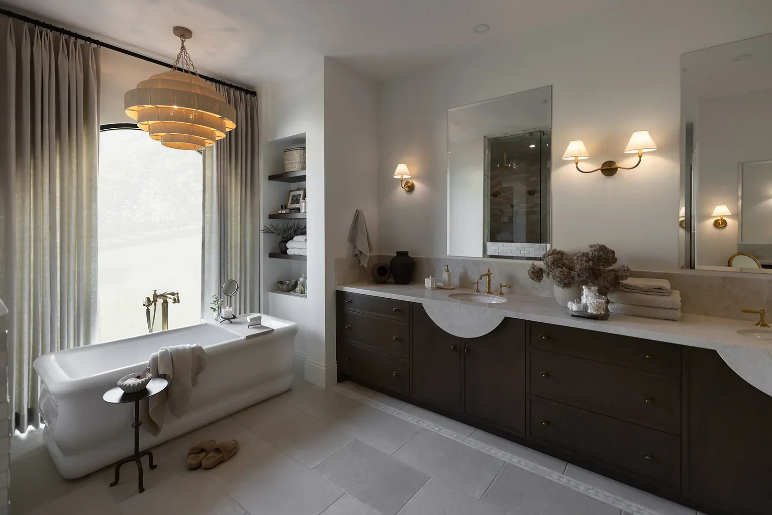 Elegant master bathroom with freestanding tub and dark vanity