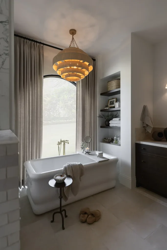 Elegant bathroom with freestanding tub and chandelier